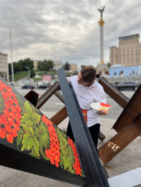 Культурний фронт: у центрі Києва художниця розмальовує протитанкові “їжаки”